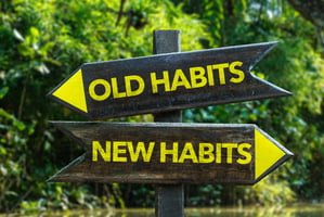 sign with arrows pointing to old habits and new habits